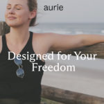 A woman sitting peacefully with the ocean in the background. "Designed for Your Freedom" appears in the center.