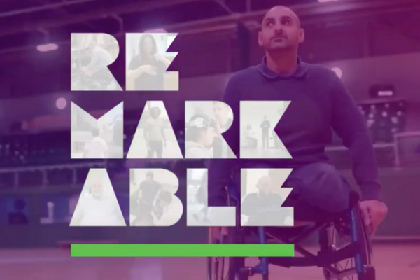 a photo of a man in a wheelchair with the logo for Remarkable.