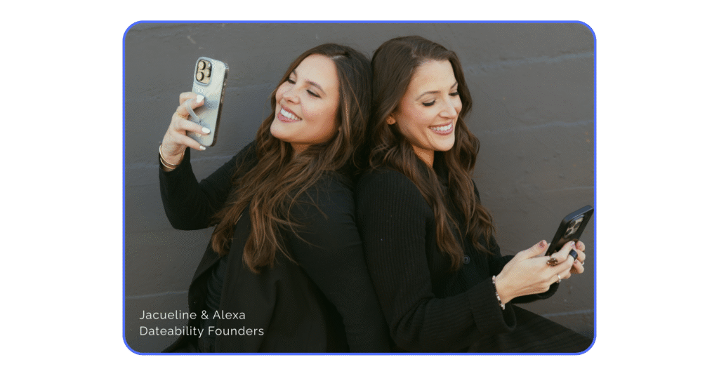 Two women in dark clothing witting with their backs to each other while looking at their smart phones. They are smiling joyfully. In the bottom left corner it says "Jacqueline & Alexa, Dateability Founders".