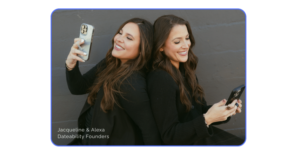 Two women in dark clothing witting with their backs to each other while looking at their smart phones. They are smiling joyfully. In the bottom left corner it says "Jacqueline & Alexa, Dateability Founders".