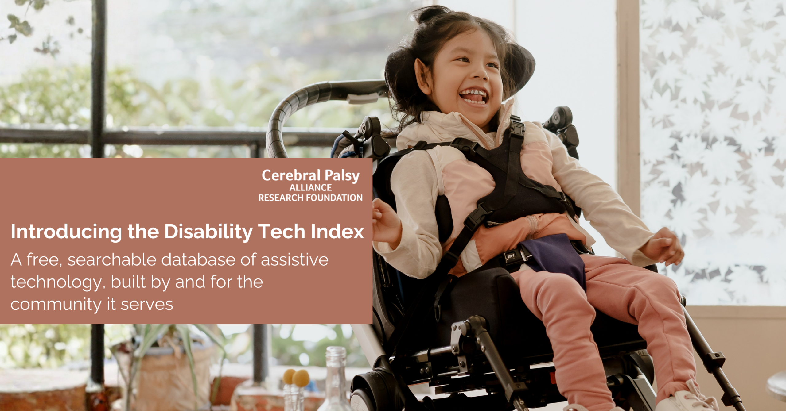A smiling young child sits in a supportive wheelchair indoors near large windows with natural light streaming in. The child wears a pink outfit and appears joyful and engaged. Overlaid text reads: “Introducing the Disability Tech Index — A free, searchable database of assistive technology, built by and for the community it serves” alongside the Cerebral Palsy Alliance Research Foundation logo.